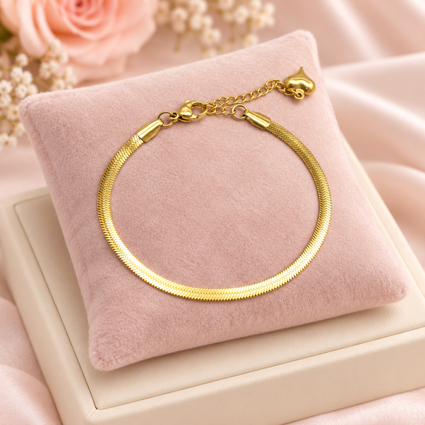 Bracelet Gold Line doré à maille plate de 3 mm sur présentoir rose poudré