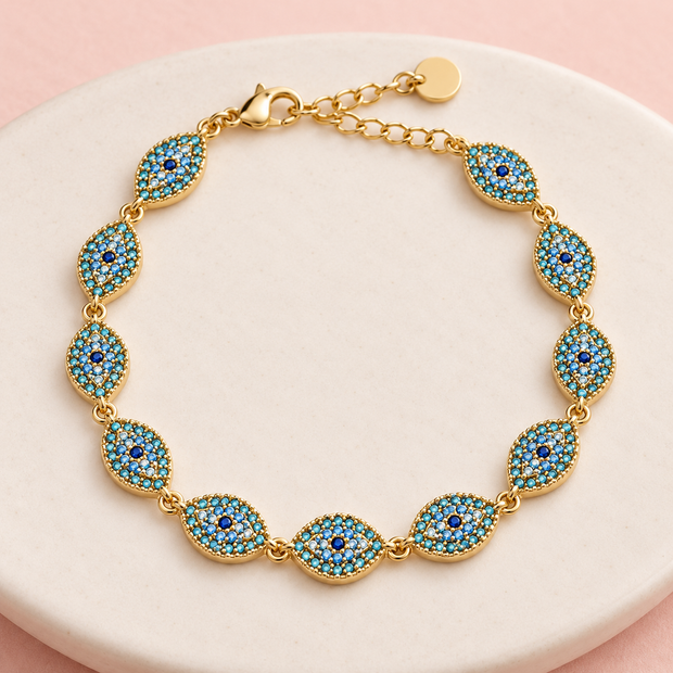 Bracelet Nazar doré à motifs œil – Turquoise sur support ivoire