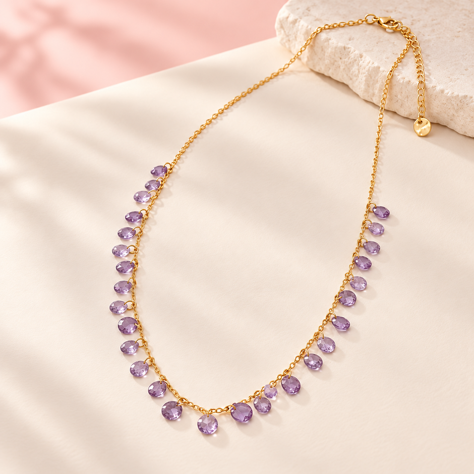 Collier Éclats de couleur violet, chaîne dorée et pampilles facettées lilas sur fond ivoire